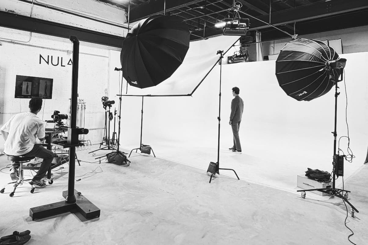 Black and white photograph of a model shoot on the studio's white cyclorama