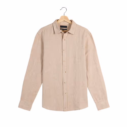 Beige linen shirt on a wooden hanger against a white background