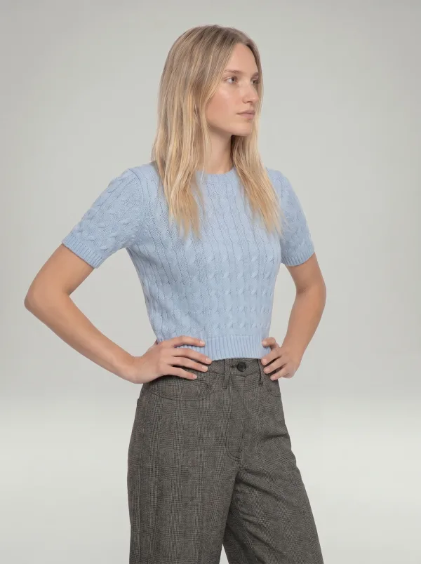 The same sweater worn by a model with grey check trousers